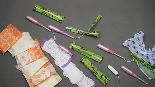 Menstrual cup vs single-use sanitary pads, tampons. Zero waste, eco friendly and minimalism lifestyle. Plastic packaging and waste of the woman hygiene products. The problem of environmental pollution