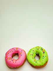 two colorful donuts isolated on a white background.