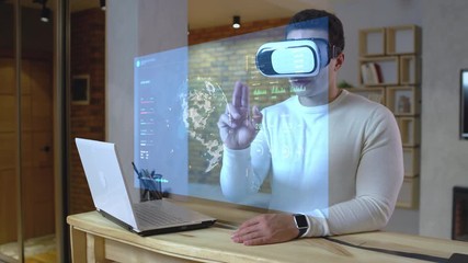 Financial analyst working with stock market chart holograms, futuristic tech. Virtual screen, heads up display, augmented reality - Powered by Adobe