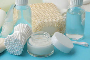 Various personal care products. Face cream, Soap, lotions, cotton pads and sticks on a blue phone. spa.