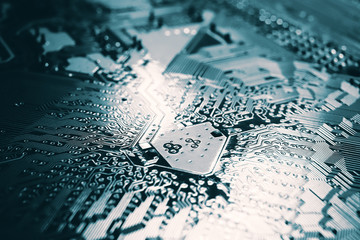 Fototapeta premium Blue electronic mother board circuit close up macro background.