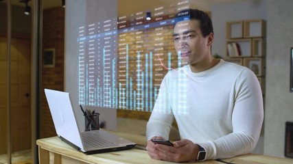 Young financial advisor looking at stock market data hologram, working remotely. Virtual screen, heads up display, augmented reality - Powered by Adobe