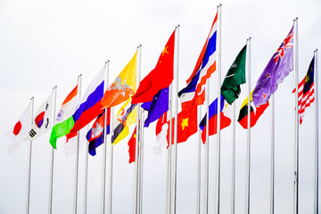 Flags of different countries on the background of a white sky