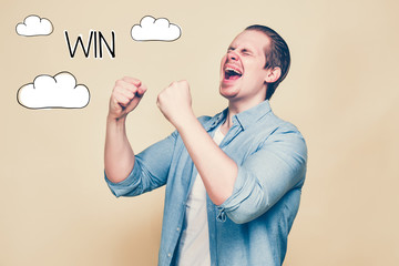A man in a shirt rejoices in victory, clenching his fists and screaming. An abstract inscription win next to the clouds. Toned.