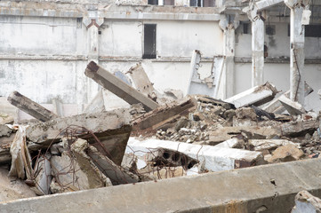 The remains of a large building destroyed in a foggy haze. Background.