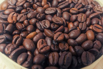 coffee grains in a round bowl close-up. retro toning
