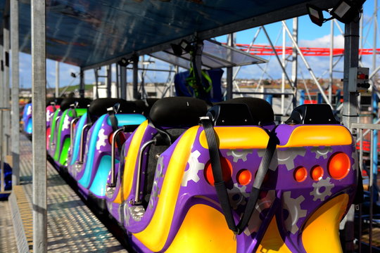 Colorful amusement park funfair rides and vintage slot machines with vibrant colours background stock photo