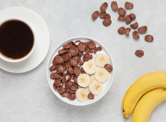 Crispy chocolate flakes in a bowl with milk and banana. Delicious healthy Breakfast