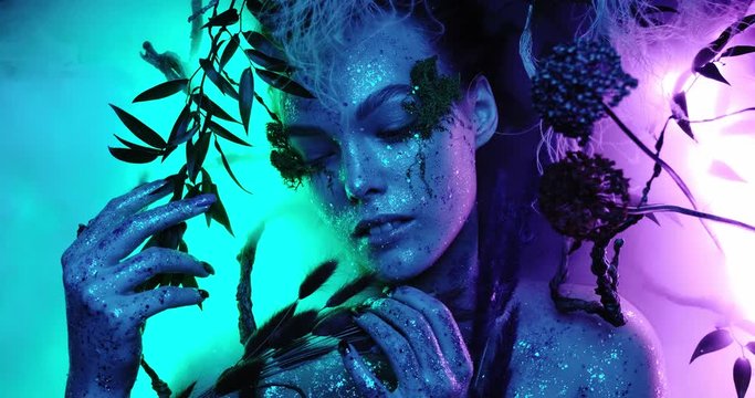 Fantasy world, a fabulous beautiful girl nymph or elf looks at the camera and poses with bright neon colors blue and purple creating magic around her fog, closeup portrait 4k quality