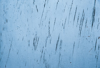 Thin strokes of black on a faded pastel blue old metal surface. Abstract background, texture.