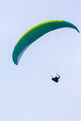 Skydiver On Colorful Parachute In Sky. Active Hobbies