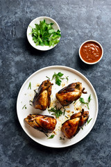 Roasted quails on white plate