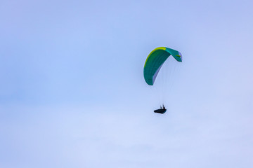 Skydiver On Colorful Parachute In Sky. Active Hobbies