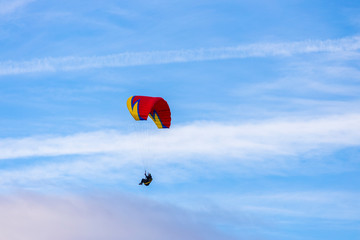 Skydiver On Colorful Parachute In Sky. Active Hobbies