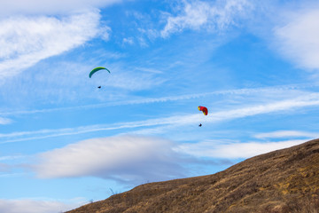 Fototapeta na wymiar Skydiver On Colorful Parachute In Sky. Active Hobbies