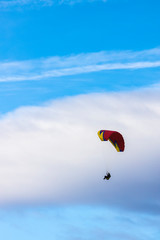 Skydiver On Colorful Parachute In Sky. Active Hobbies