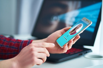 Woman unlocking smartphone using facial recognition technology system. Biometric verification identification and face id scanning. High tech technology