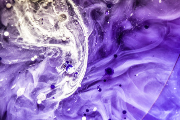 Beautiful abstraction in shades of blue and purple of liquid paints © dominikab