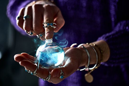Fantasy witch wizard woman using enchanting magical elixir potion bottle for love spell, witchcraft and divination. Magic illustration and alchemy