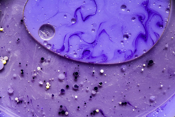 Beautiful abstraction in shades of blue and purple of liquid paints © dominikab