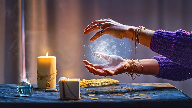 Magical luminous swirling glowing ball in the palm of a witch wizard woman during a witchcraft and occult esoteric spiritual ritual. Magic and sorcery