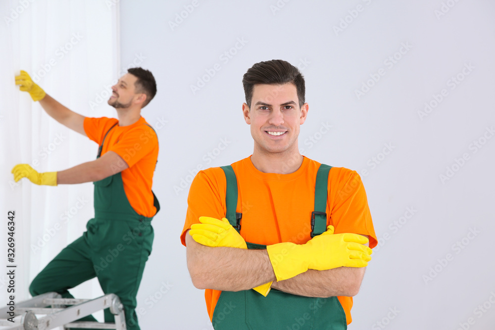 Poster team of professional janitors cleaning room after renovation