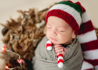Funny newborn holding candy