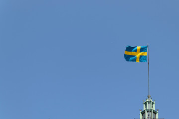 Stockholm flag in the sky. Beautiful clear blue sky in the background of the sky State symbol of Sweden