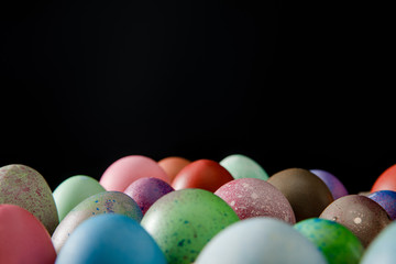 Fototapeta na wymiar Selective focus of colorful Easter eggs isolated on black