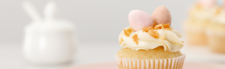 Selective focus of cupcake on grey background, panoramic shot