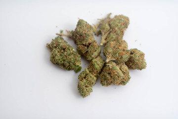 marijuana buds spread over white copy space empty