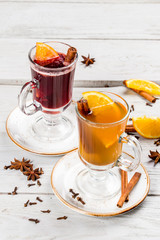 Mulled wine with cinnamon and orange in a glass transparent glass.
