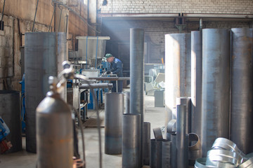 Ventilation pipe factory. Metal processing industry. Workshop with ventilation metal pipes