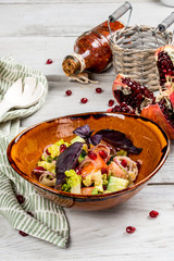 Georgian vegetable salad with cucumbers, tomatoes, herbs and pomegranate.