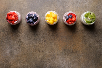 Variety of yogurts in glass jars. Healthy breakfast concept. Food background