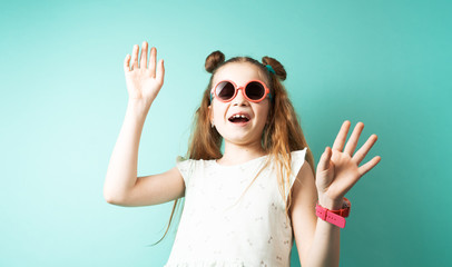 Bright colors: a girl in sunglasses on a green background.