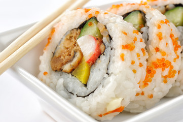 Futomaki (roll sushi) chopsticks on white background