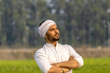 portrait of a farmer standing in field and thinking © Ankit
