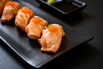 grilled salmon sushi on black plate