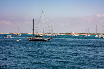 Fototapeta premium Some sailboats and yachts in the sea between Ibiza and Formentera in the Balearic islands in Spain.