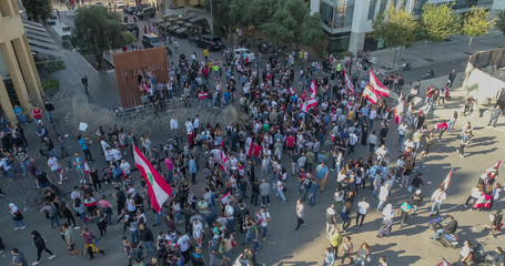Beirut, Lebanon 2019: Aerial drone shot of numerous protestes at Martyrs' Square facing the police and trying to remove wires blocking the road.