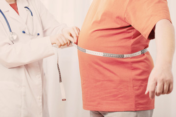 doctor measures  man measures  waist