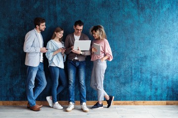 The connected team is an efficient team. Group of businesspeople using wireless technology together...