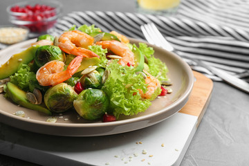 Tasty salad with Brussels sprouts served on grey table