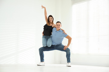 Happy young couple dancing in empty studio