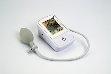 An electronic tonometer, white, for measuring blood pressure. Background for health and medicine.