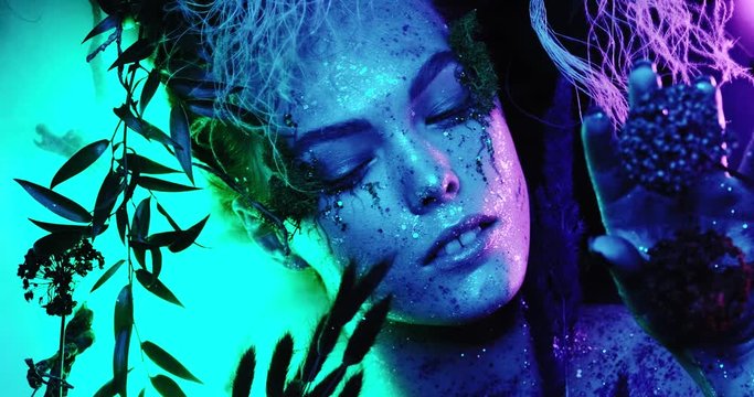 a very beautiful haute couture model with makeup posing in neon glows with a bright and saturated color. Looks at the camera in high quality 4k close-up looks like a fantasy world.