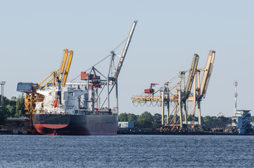 MARITIME TRANSPORT - Freighter at the transhipment terminal in a seaport