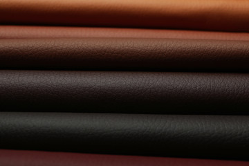 Different leather samples as background, closeup view