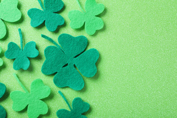 Flat lay composition with clover leaves on light green background, space for text. St. Patrick's...
